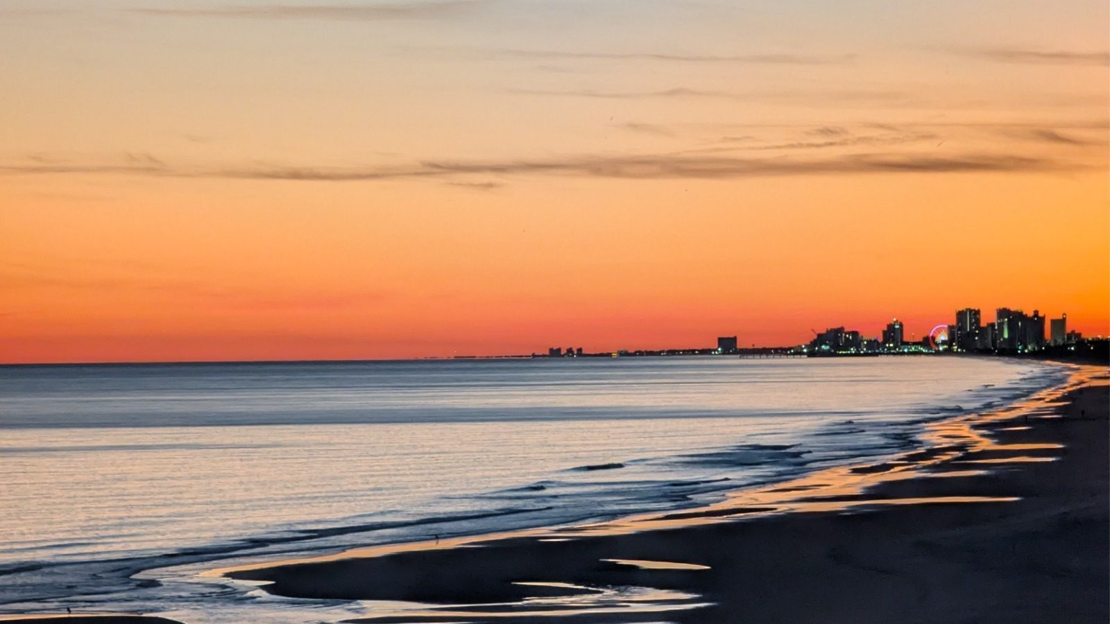 Sunset over the Myrtle Beach skyline and Ferris wheel seen from 728 Sands Beach Club